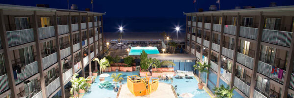 night view of hotel and pool looking toward the beach and ocean